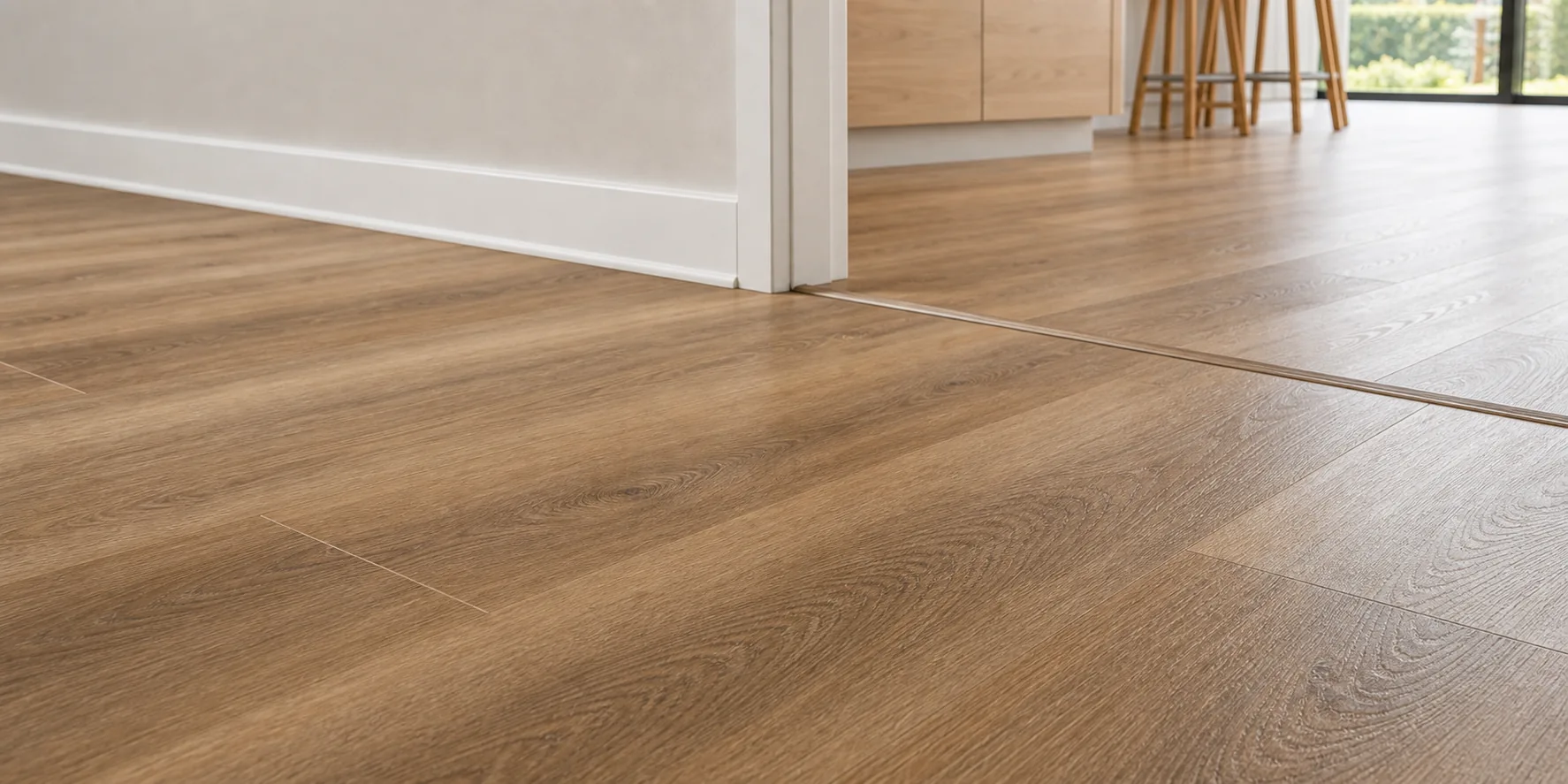 Close detail of timber-look resilient plank flooring with a tidy finished edge